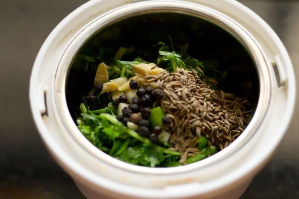 chopped coriander leaves, black pepper, chopped green chilies, chopped ginger and garlic added in a grinder jar. 