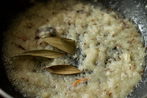sauteing ground onion-ginger-garlic paste in the pan