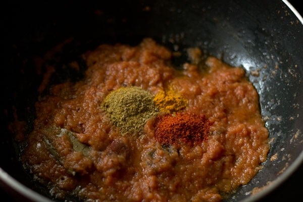 ground spices added to masala paste in the pan