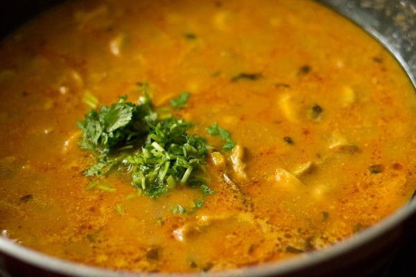 coriander leaves added to mushroom masala in pan