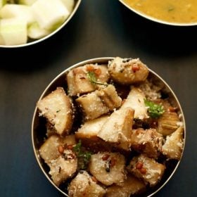 vazhakkai poriyal garnished with chopped coriander leaves and served in a steel bowl with text layover.