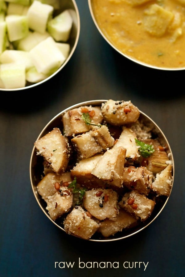 The vazhakkai poriyal is garnished with chopped coriander leaves and served in a steel bowl with text in the middle.