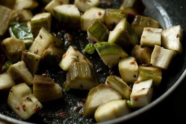 water added to raw banana pieces in the pan.