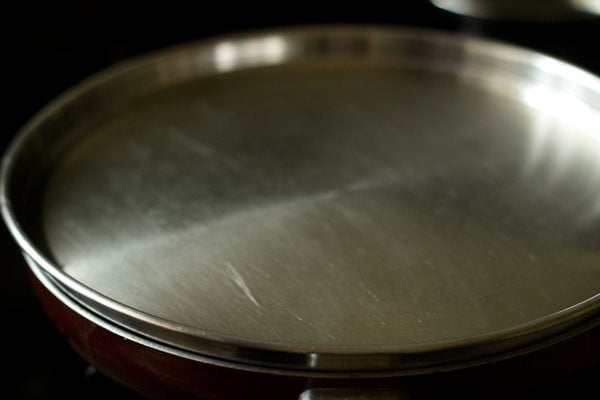 cooking vazhakkai poriyal in the covered pan. 