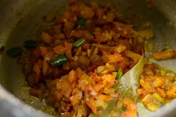 cooked tomatoes in cooker to make green gram dal.