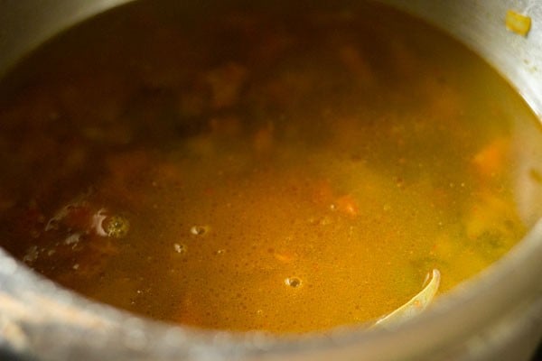 water in cooker to make green gram curry.