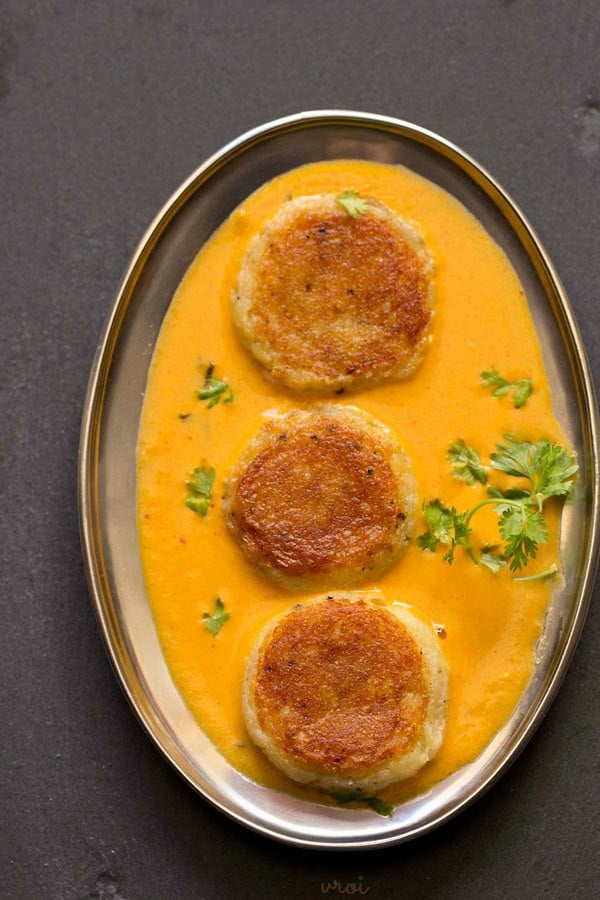 aloo kofta garnished with coriander leaves and served in a steel bowl. 