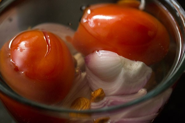 tomatoes, onion and almonds added in boiling water. 