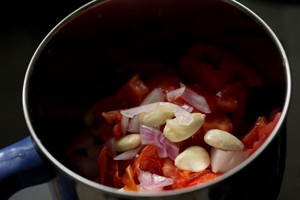 roughly chopped boiled tomatoes, onions and boiled, peeled almonds added to the grinder jar. 