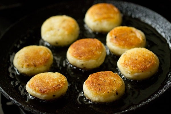 shallow frying prepared aloo kofta in hot oil till evenly golden from both sides. 