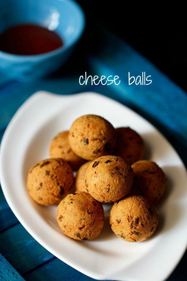 cheese balls served in a white tray on a blue board