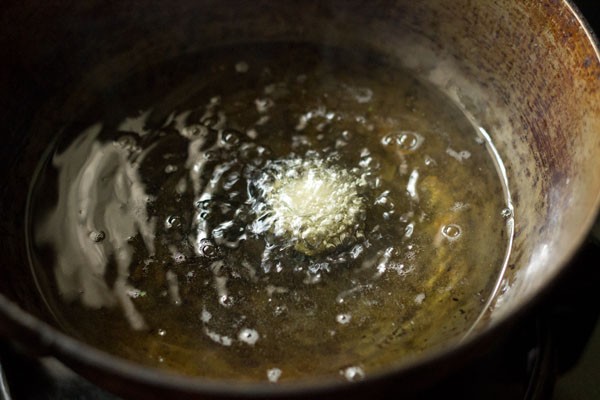 tester cheese ball added to hot oil is bubbling in pan