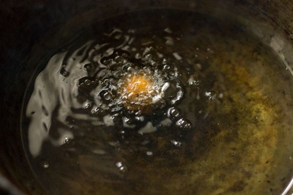 tester cheese ball is turning golden and bubbling while frying