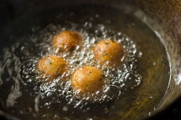 frying cheese balls are getting darker golden brown