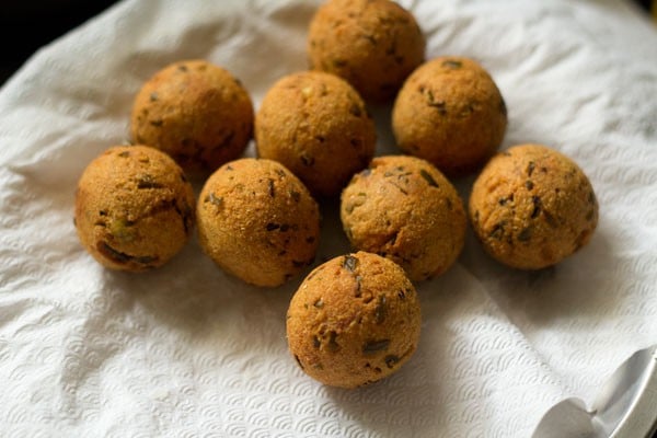 completed fried cheese balls draining on a paper towel