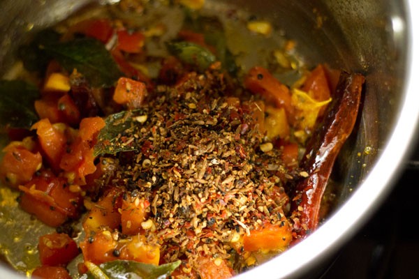 prepared rasam spice mixture added to pan. 