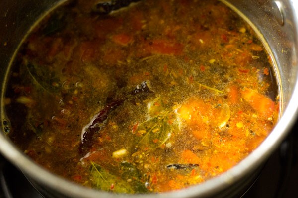 prepared tamarind pulp, water and salt added to pan. 