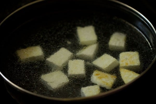 paneer soaked in water in a pan