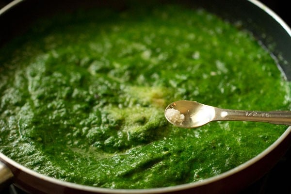 adding sugar for palak paneer recipe