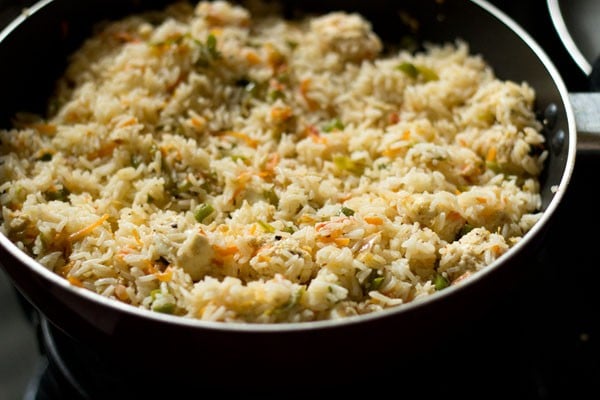 cooked paneer fried rice in the pan with right amount of salt added