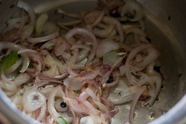sautéing onion-spice mixture to make thengai paal sadam.