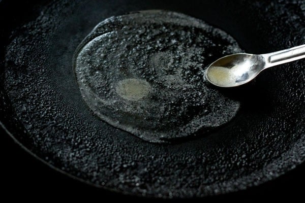 spreading butter on pan for eggless french toast