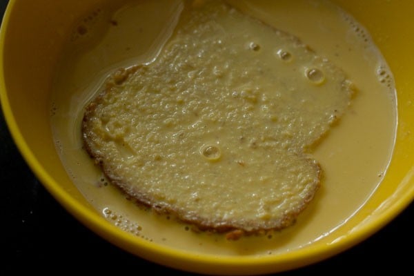 bread slice dipped in the prepared custard and milk mixture. 