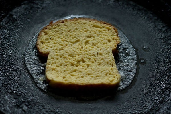 toasting the bread slice on pan