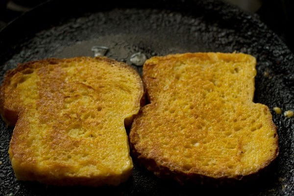 toasting two bread slices till evenly golden from both the sides. 