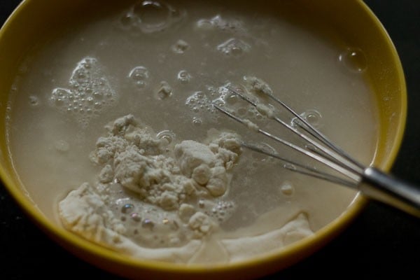 water added to the dry mixture in the bowl. 