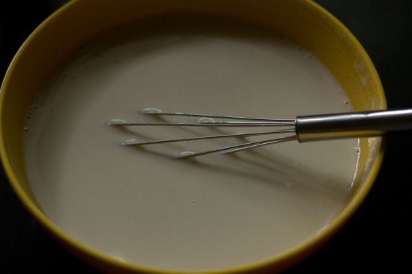 whisking the ingredients to make a smooth, thin and lump free batter. 