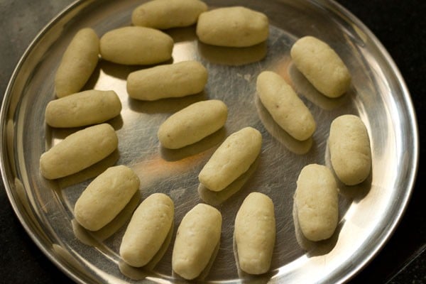 shaped kala jamuns on a steel plate. 