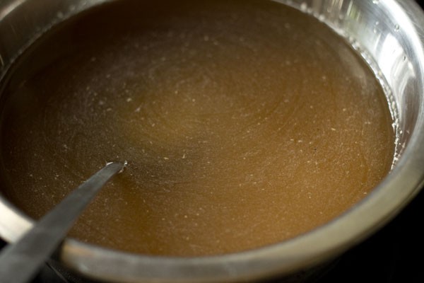 stirring sugar to make it dissolve. 