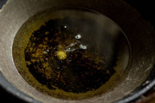 frying a test ball to make sure jamun dough is correct and oil is hot enough.