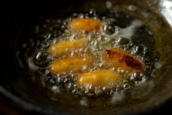 frying kala jamuns are starting to take on color.