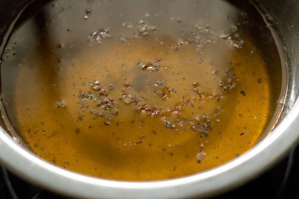 flavoring the sugar syrup with cardamom powder, saffron and rose water.