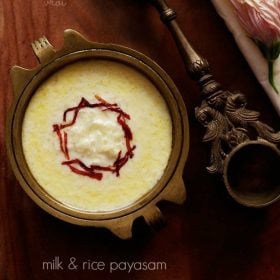 paal payasam garnished with dried rose petal chiffonade in a brass bowl with text layovers.