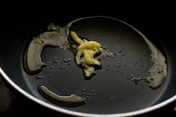 heating ghee in a thick bottomed wide pan.