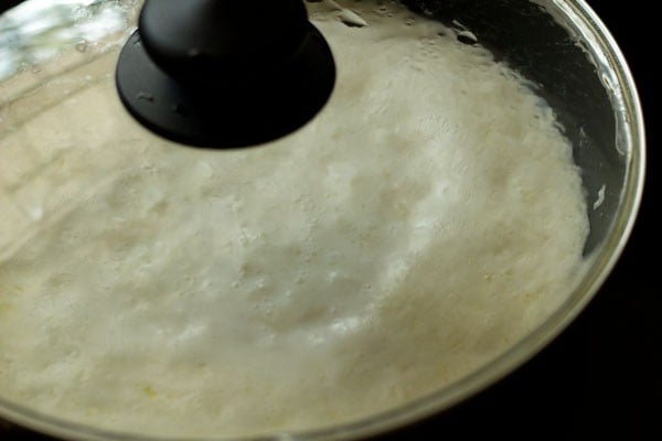 cooking cooking rice grains in the milk in the covered pan. 