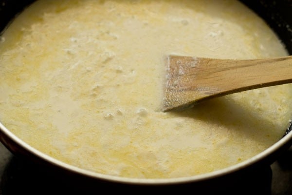 stirring the sugar in the payasam. 