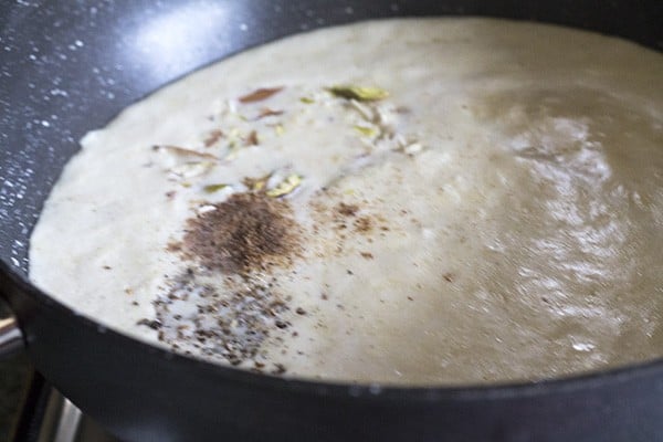 spices added to the pot for the pumpkin kheer recipe, kaddu ki kheer recipe, pumpkin payasam recipe.