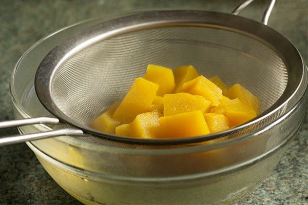 straining the cooked pumpkin.