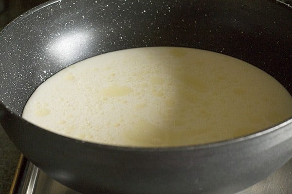 milk added to pot for making kaddu ki kheer recipe.