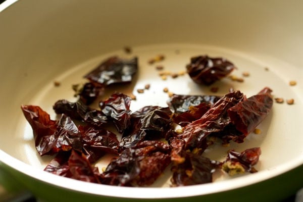 red chiles being toasted in dry pan