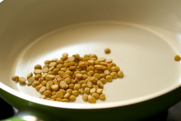 chana dal added to dry pan for toasting