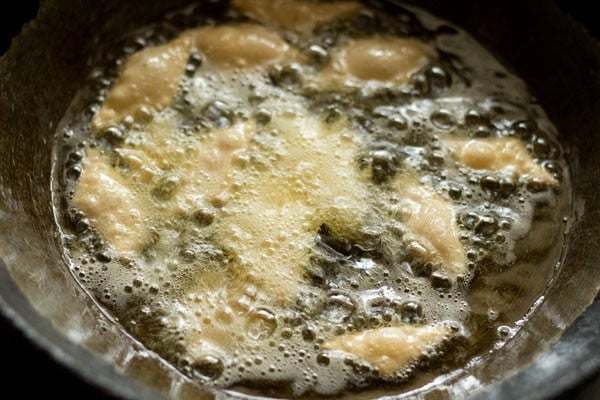 frying shakkarpare in hot oil. 