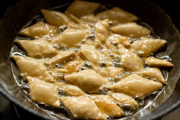 frying shakkarpare in hot oil. 