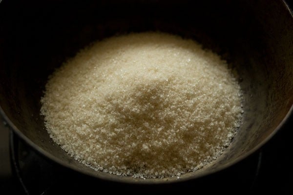 sugar added to another pan for making sugar syrup for shakkarpara. 