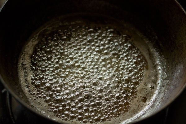 sugar syrup bubbling the pan for shakkarpara. 