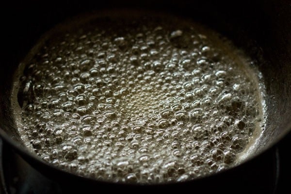 sugar syrup bubbling the pan for shakkarpara. 